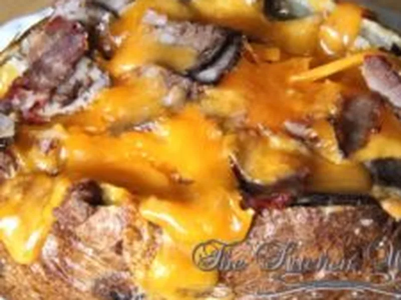 Cheesy Shaved Beef Stuffed Baked Potatoes with Caramelized Onions