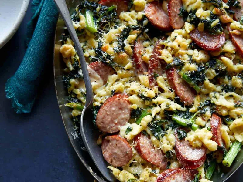 Sausage Kale and Spaetzle Pesto Bake with Creamy Parmesan Sauce