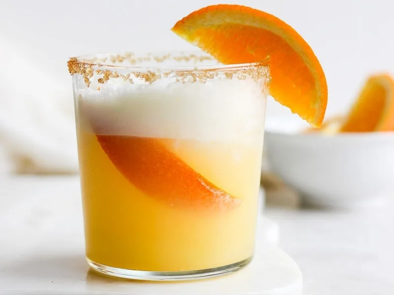 Frothy Orange Creamsicle Cocktail with Chili Sugar Rim