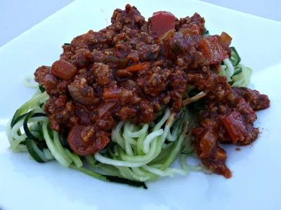 Spicy Sausage and Peppers Over Zucchini Noodles