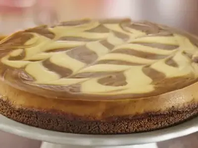 Caramel Apple Butter Marbled Cheesecake with Gingersnap Crust