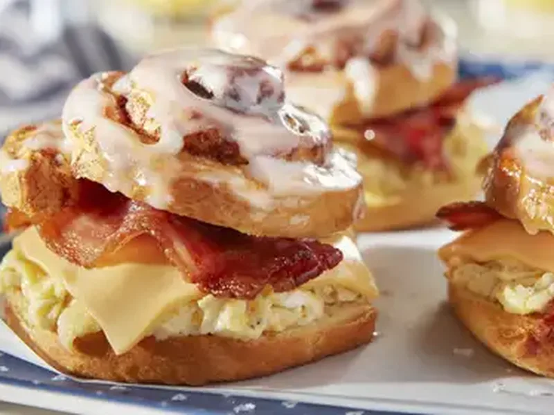 Cinnamon Roll Breakfast Sandwich with Bacon and Scrambled Eggs