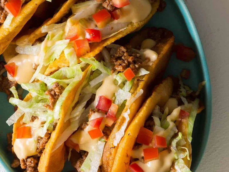 Crunchy Ground Beef Tacos with Homemade Cheese Sauce