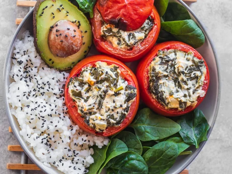Baked Stuffed Tomatoes with Cashew Creamed Spinach and Rice